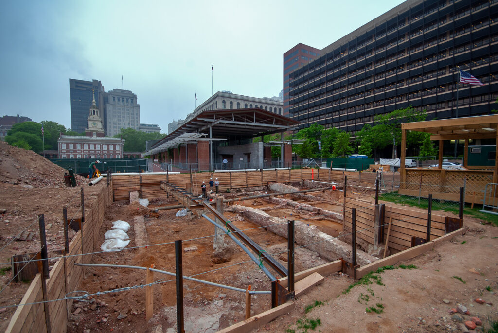 View of the archaeological excavation of the President's House Site in Independence National Historical Park in Philadelphia, Pennsylvania, with the Liberty Bell Pavilion and Independence Hall in the background.